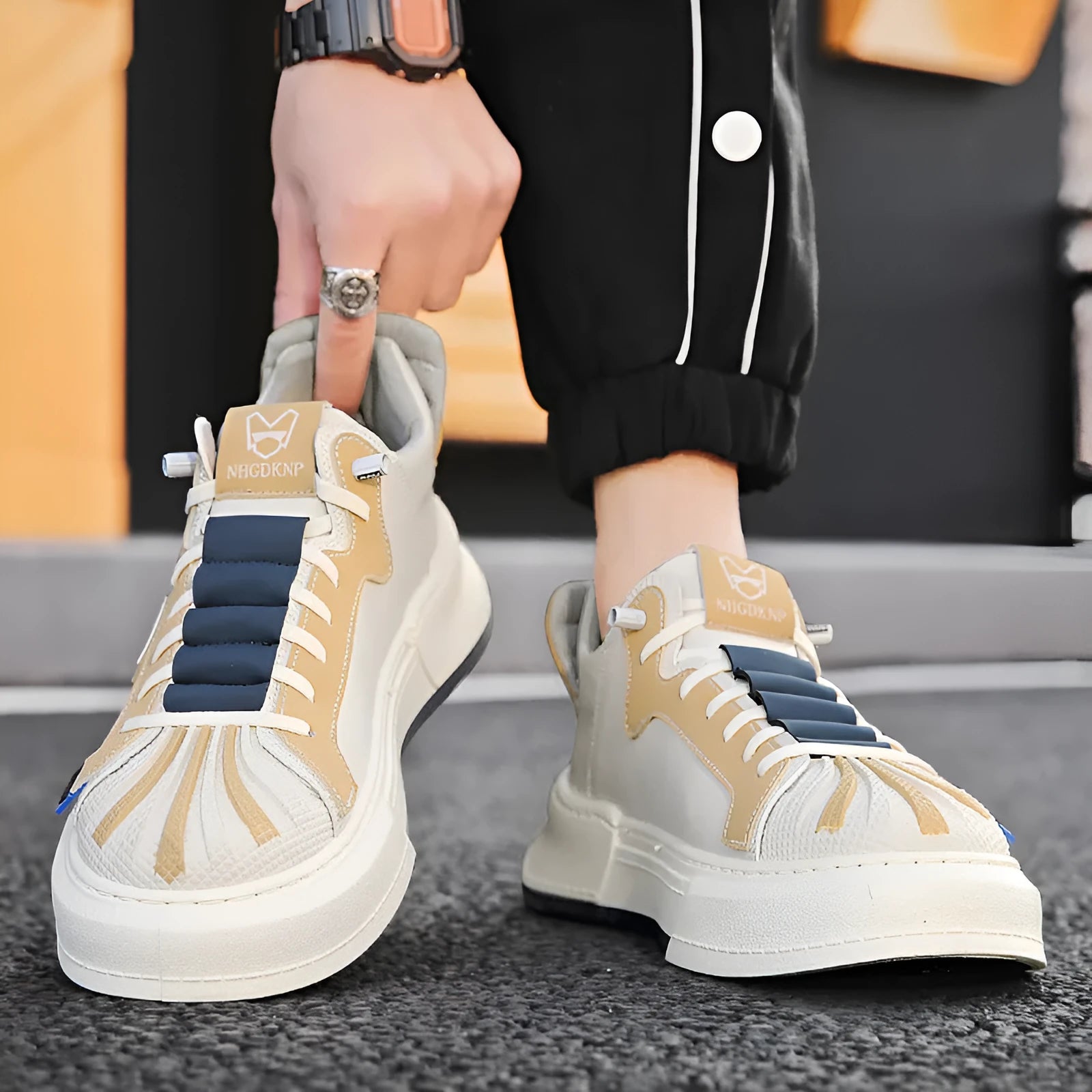 Men's beige low-top sneakers with elastic band closure and leather stitching detailing