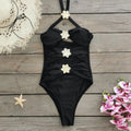A solid colour one-piece swimsuit for women with a hollow-out tube top and a matching short skirt.