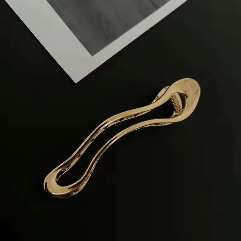 Gold and silver zinc alloy hair barrettes in square, arc, and triangle shapes.