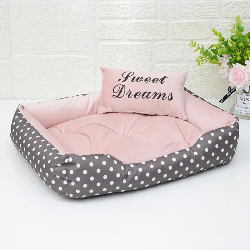 Polka dot print square dog bed with raised sides and a matching embroidered pillow in grey.