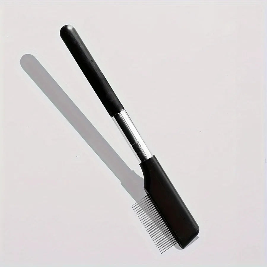 Black pet grooming brush with soft silicone bristles and a built-in comb for dogs and cats.