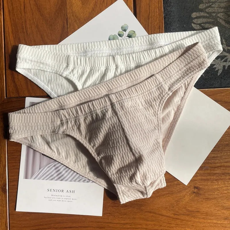 Men's solid colour cotton triangle briefs with a mid-waist waistband on a white background.