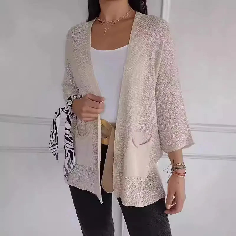 Women's thin waffle weave cardigan coat in army green with pockets, shown on a hanger.