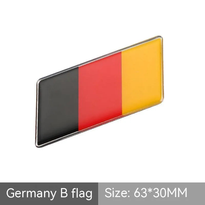 Aluminium metal car sticker with national flag design in a parallelogram shape.