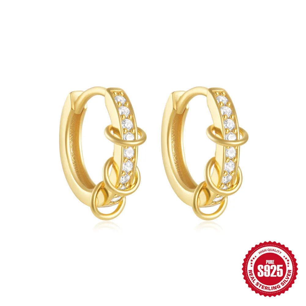 Sterling silver geometric stud earrings with a small round shape and classic diamond detail on a white background.
