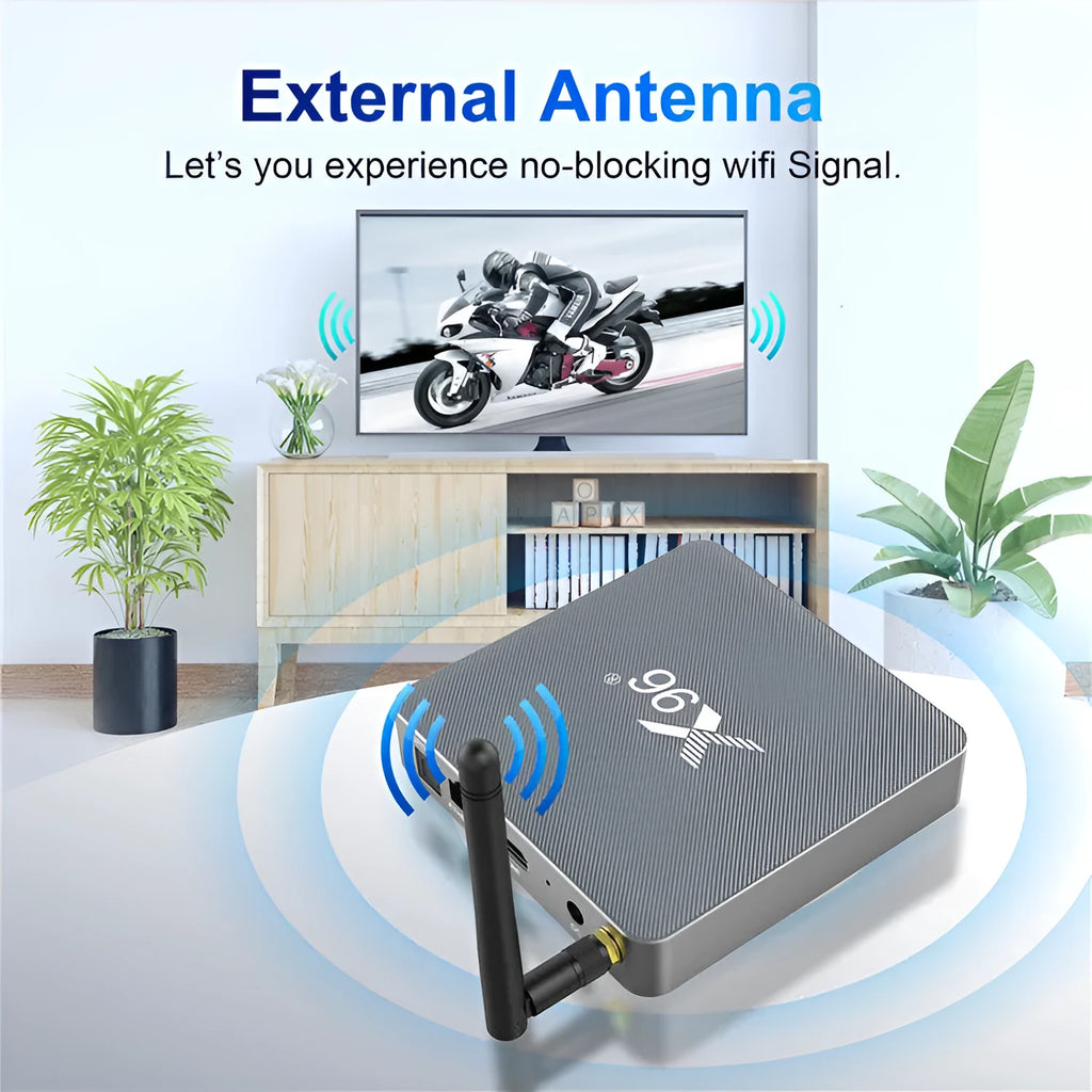 Android smart TV set-top box with voice remote control, HDMI cable, and power adapter on a table.
