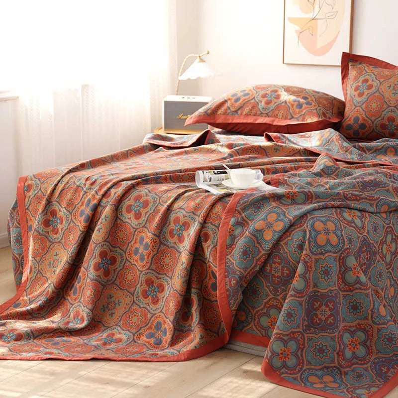 Three-piece cotton gauze bed blanket set with floral botanical pattern, shown with pillowcases.