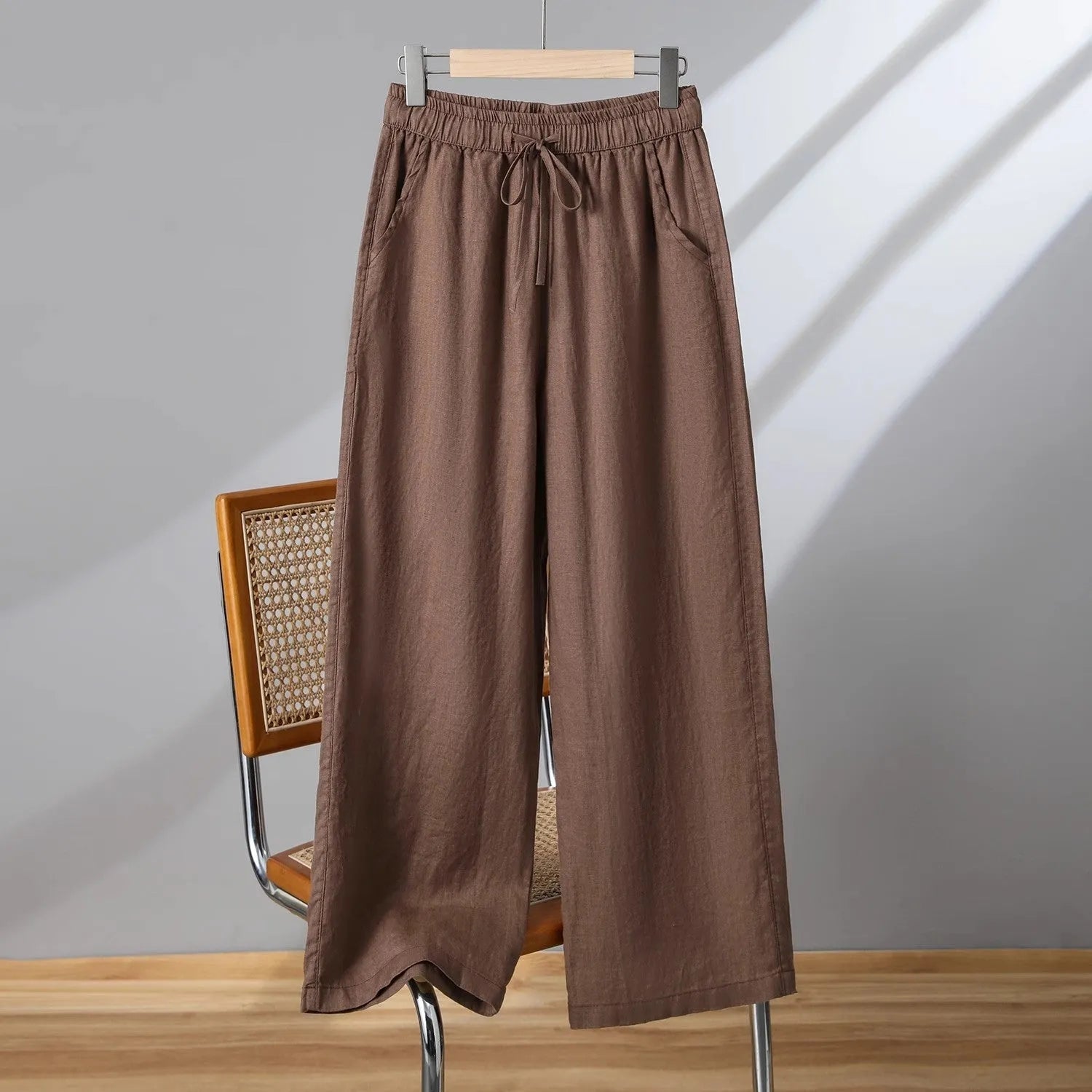 Women's straight-leg casual trousers in apricot colour with elastic waist and lace-up drawstring detail