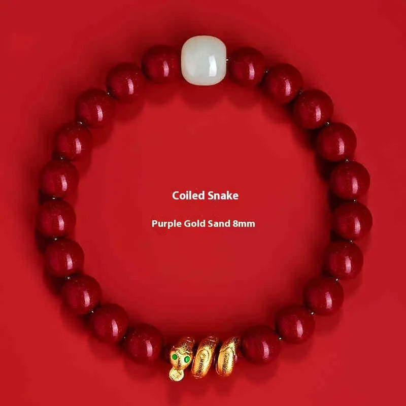 Handmade red cinnabar bracelet with snake Zodiac bead on a wrist, showing 8mm bead size.
