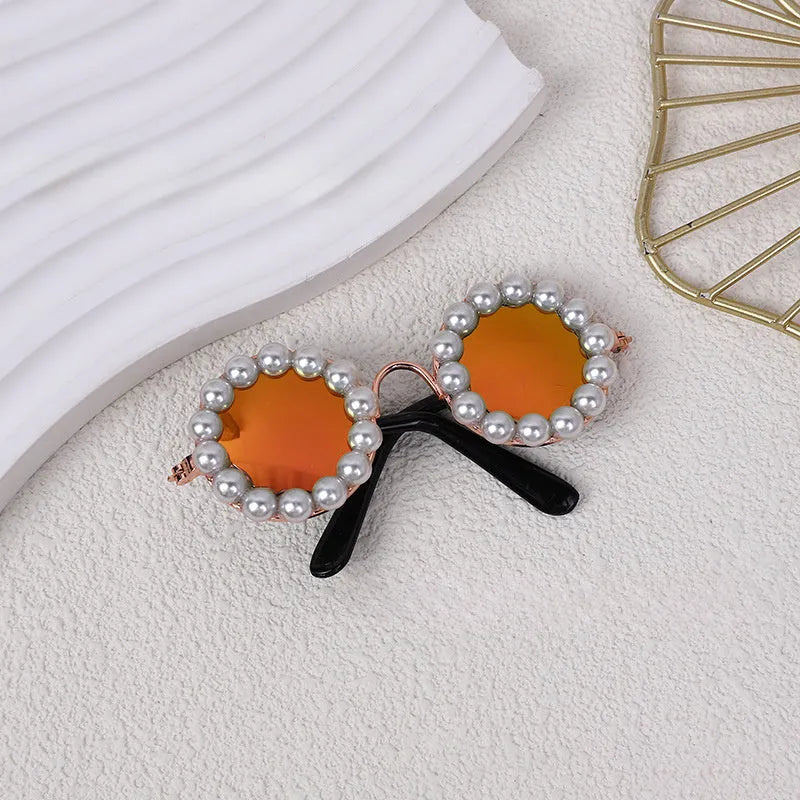 Pearl-rimmed round sunglasses for cats and dogs in multiple colours as costume accessories