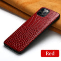 Black leather iPhone case with a crocodile pattern texture lying flat.