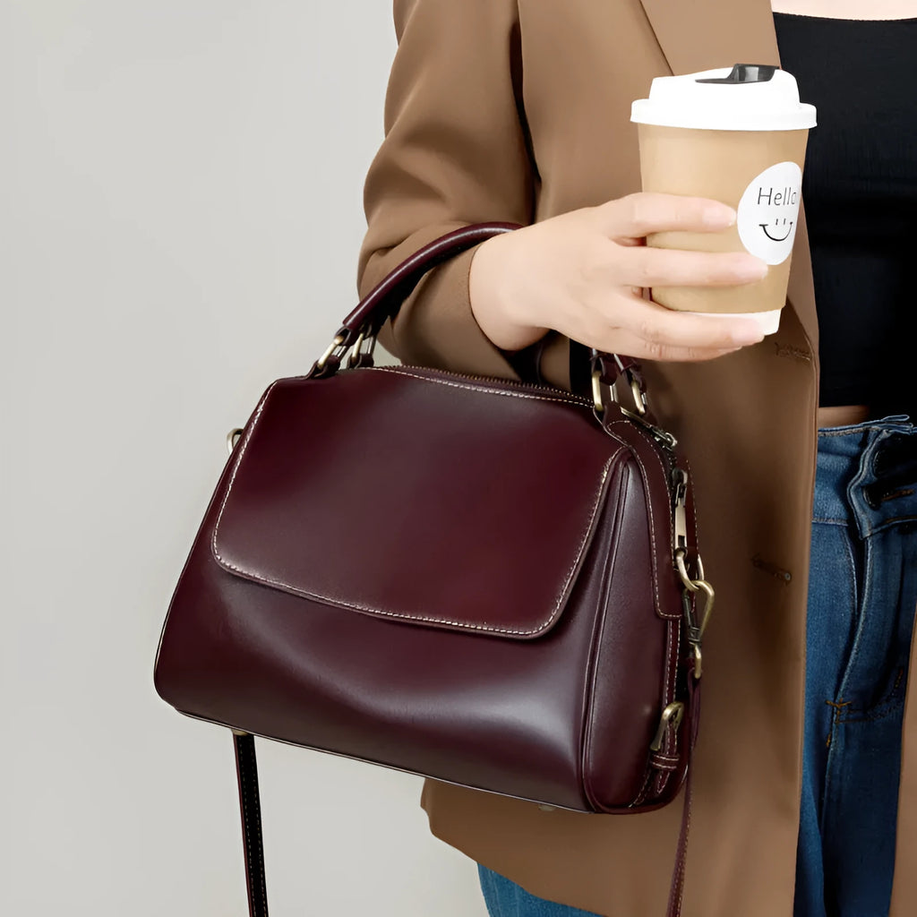 Women's genuine leather crossbody tote bag in apricot colour showing internal compartments and shoulder straps.