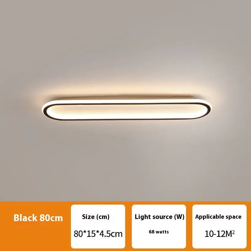 Minimalist black strip ceiling lamp with aluminium body and PVC shade mounted on a white ceiling.