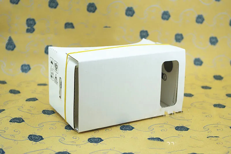 Pink and white cardboard VR glasses for smartphones with head strap and 3D lenses.