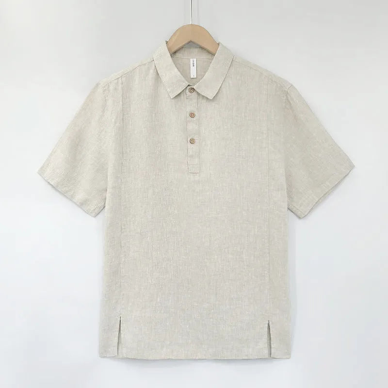 Men's loose grey green linen summer top with thin lapel collar and short sleeves laid flat.