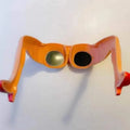 Orange plastic novelty sunglasses with leg and hip design measuring 15x20cm