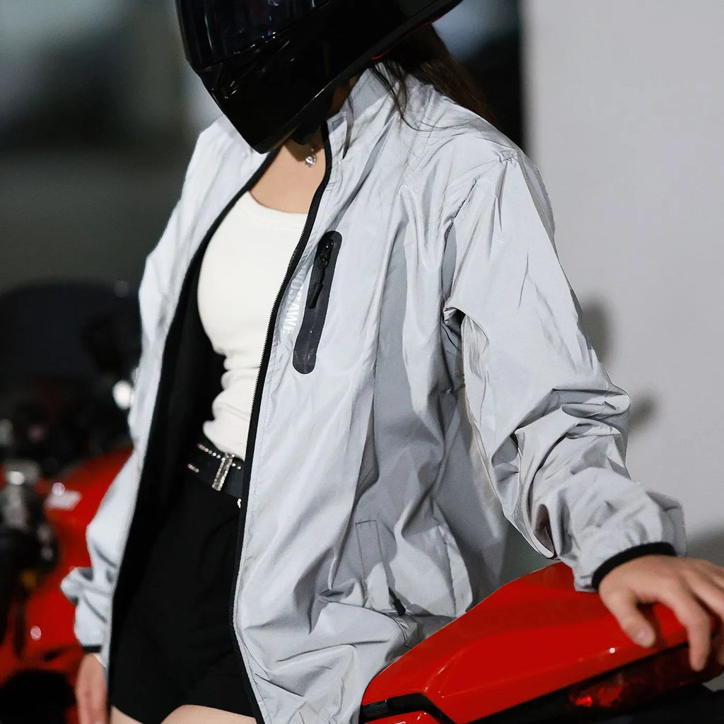 Silver waterproof polyester long sleeved top shown on a hanger.