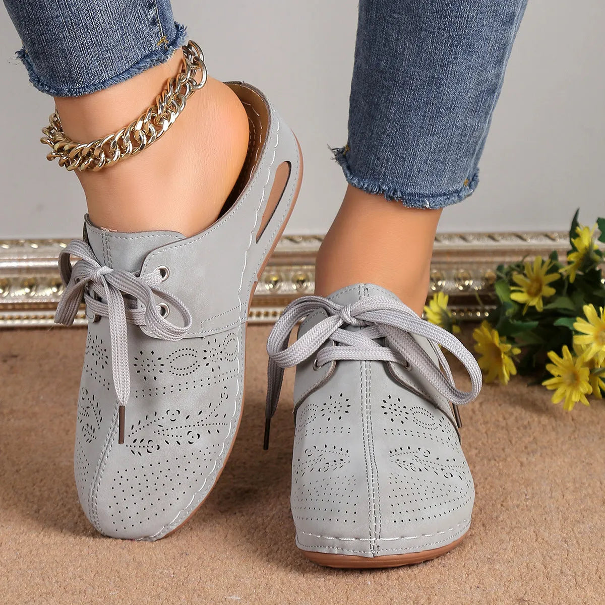 Women's black suede lace-up wedge slippers with a baotou toe and hollow out heel on a rubber sole.