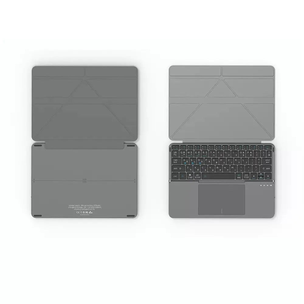 Grey Bluetooth folding keyboard unfolded next to mobile phone showing wireless connectivity for typing