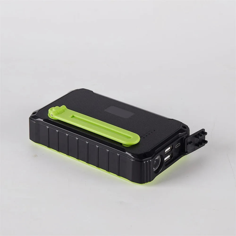 Orange and green hand solar power bank with solar panel, hand crank, dual USB ports, and LED light