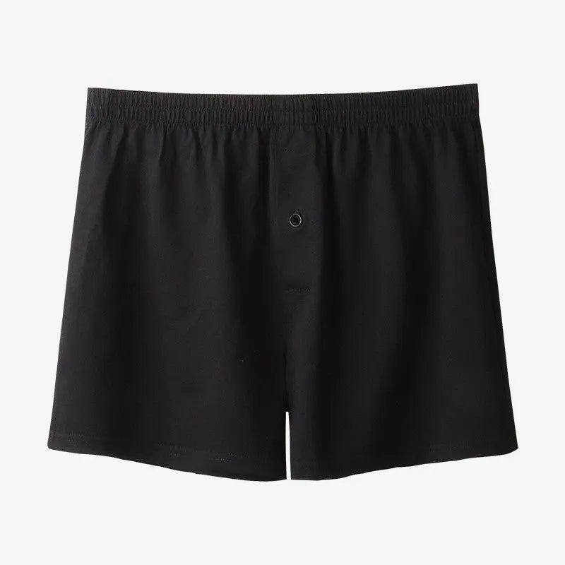 Men's solid-colour pure cotton boxer shorts with a high-waist and loose fit on a plain background.