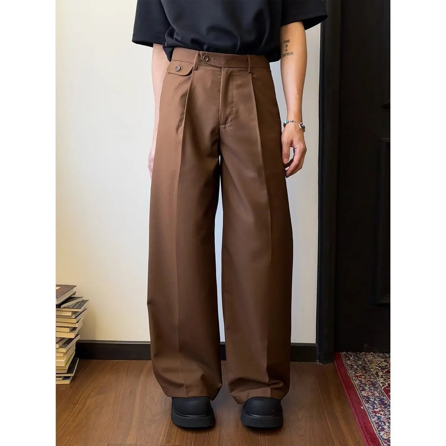 Men's brown straight-leg casual trousers with wide-leg drape fit on hanger
