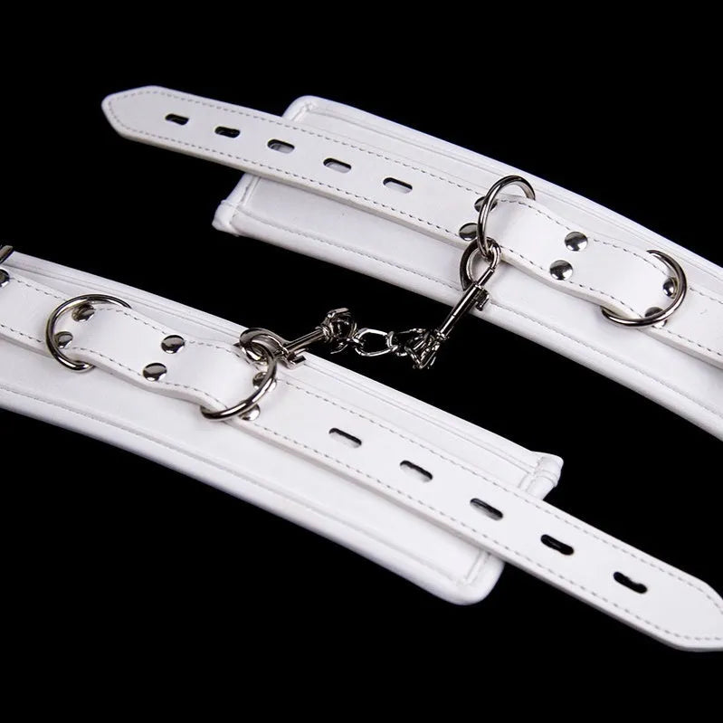 White PU sponge bondage restraint set showing handcuffs, foot cuffs, and a neck scarf.