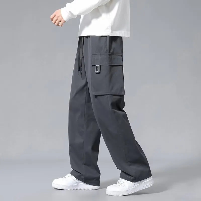 Boys in straight-leg cargo pants with drawstring waist and large side pockets, shown in army green.