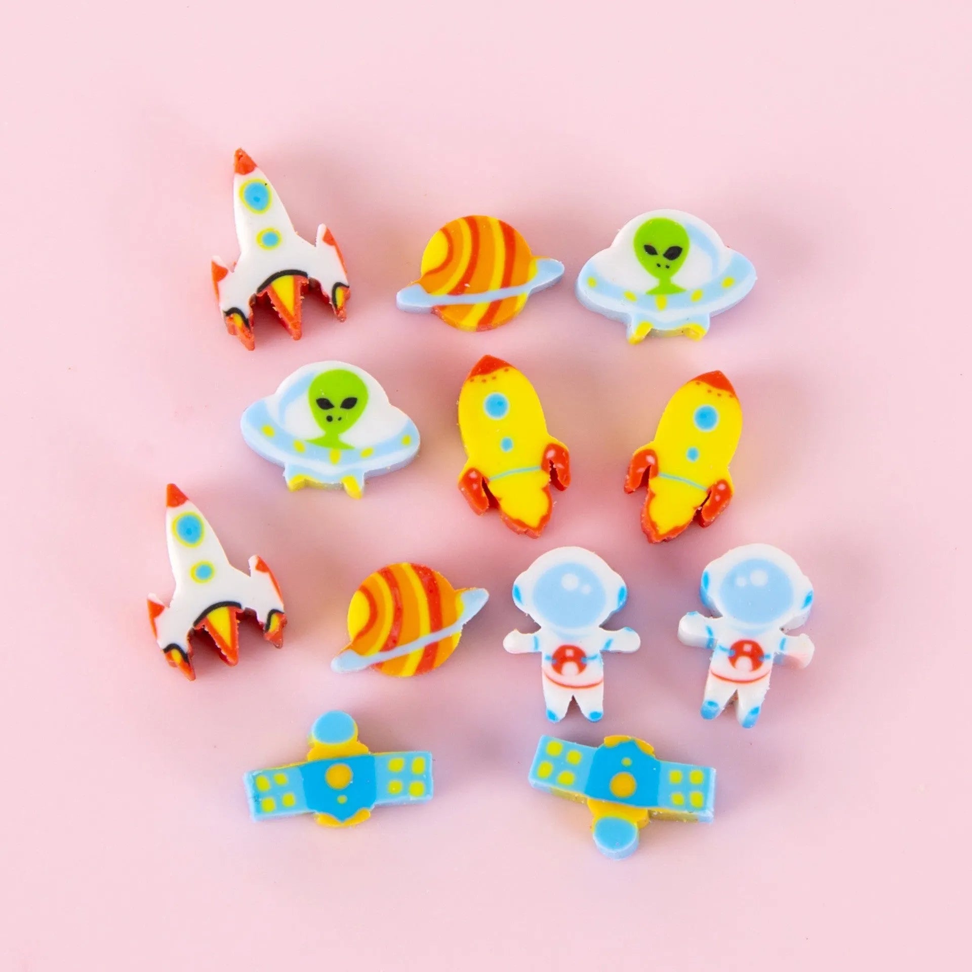 50 small colourful cartoon erasers in a pearlescent bag showing fruit, animal, cake, and Halloween themes.