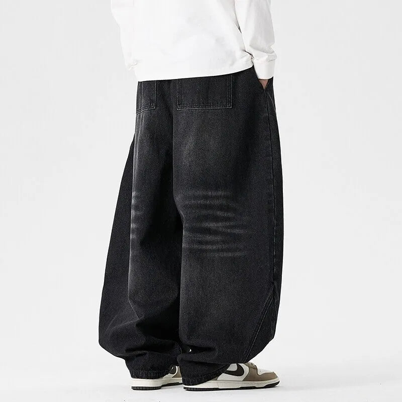 Men's plus size light blue wide leg baggy jeans on a neutral background
