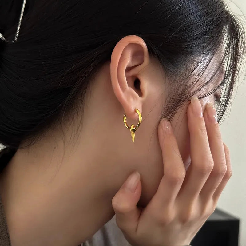 Women's geometric star-shaped ear clip with an electroplated platinum or white gold finish.