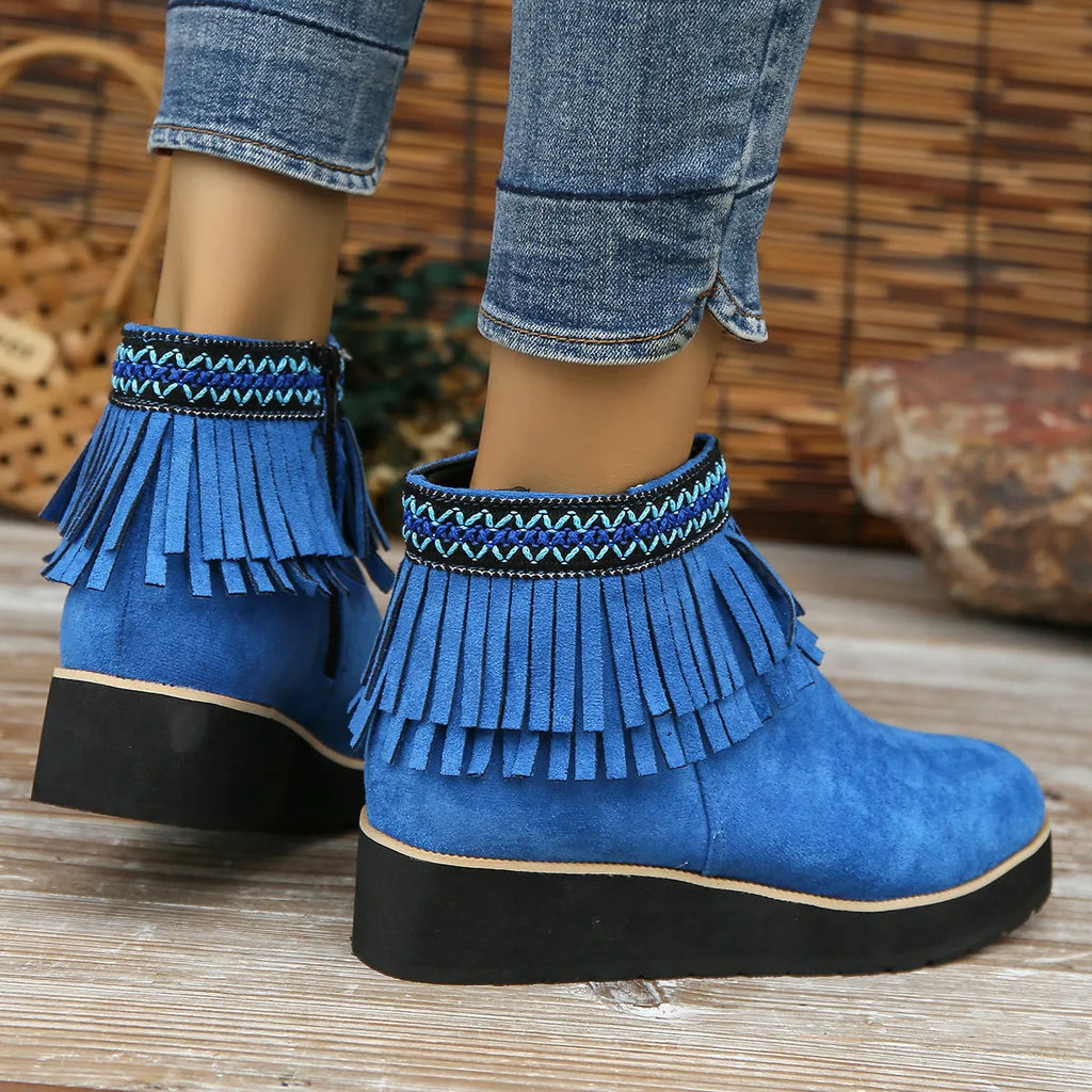 Women's black suede wedge ankle boots with side zip, tassel, and thick rubber sole.