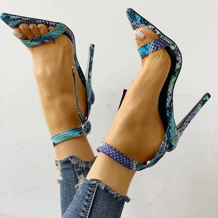 Blue women's high-heeled sandals with serpentine design, buckle fastening, and pointed toe.