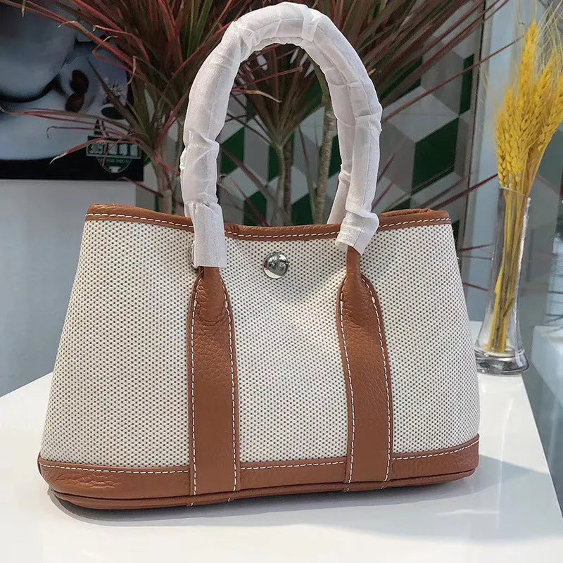 Genuine leather women's crossbody tote bag with canvas lining in bucket shape