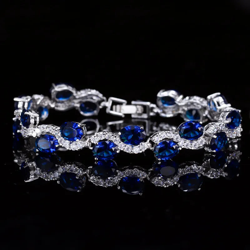 Geometric women's bracelet with zircon stones and gold-electroplated finish on copper base