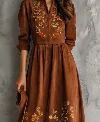Brown knee-length vintage dress with floral embroidery on suede-like material.