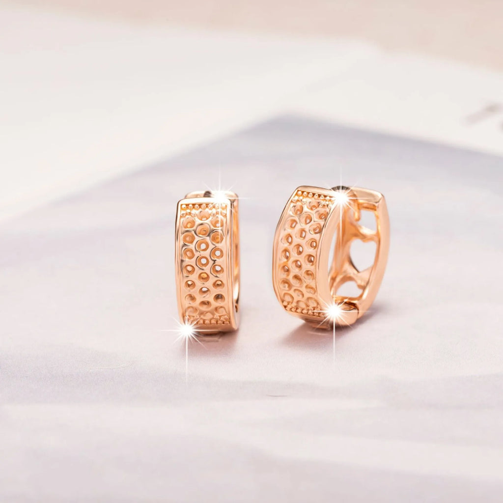 Rose gold electroplated women's earrings with three hollow heart designs in circular frame