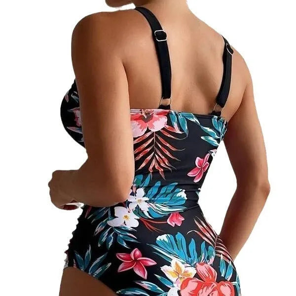 Women's floral patterned, backless one-piece swimsuit on a hanger