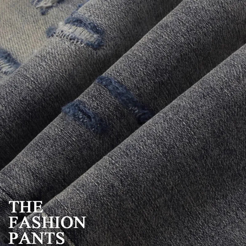 Slim fit jeans with a washed-out old colour finish, hole patches, and embroidery detail on the legs.