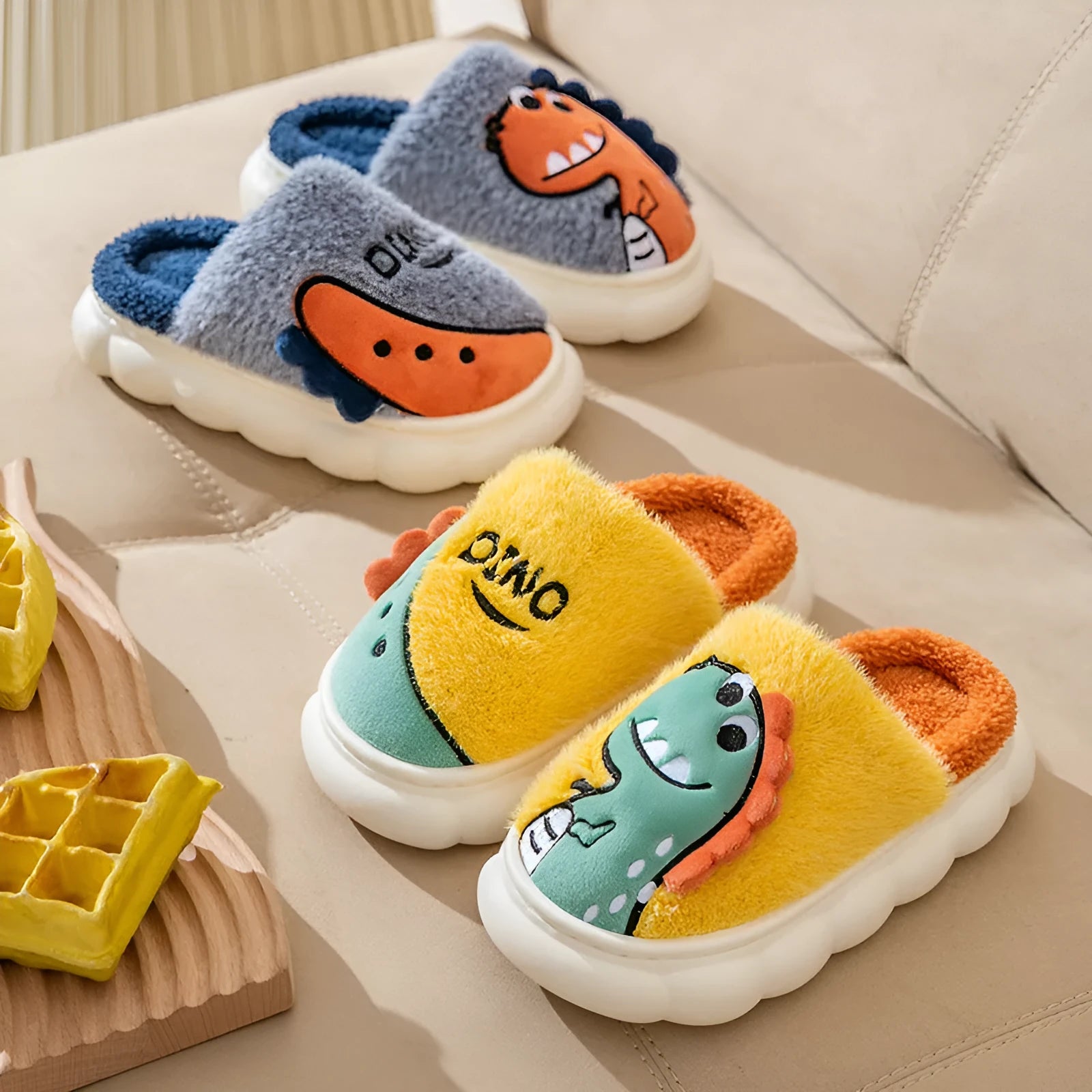 Couple set of plush dinosaur print slippers in grey, coffee, or orange, showing thick indoor design.
