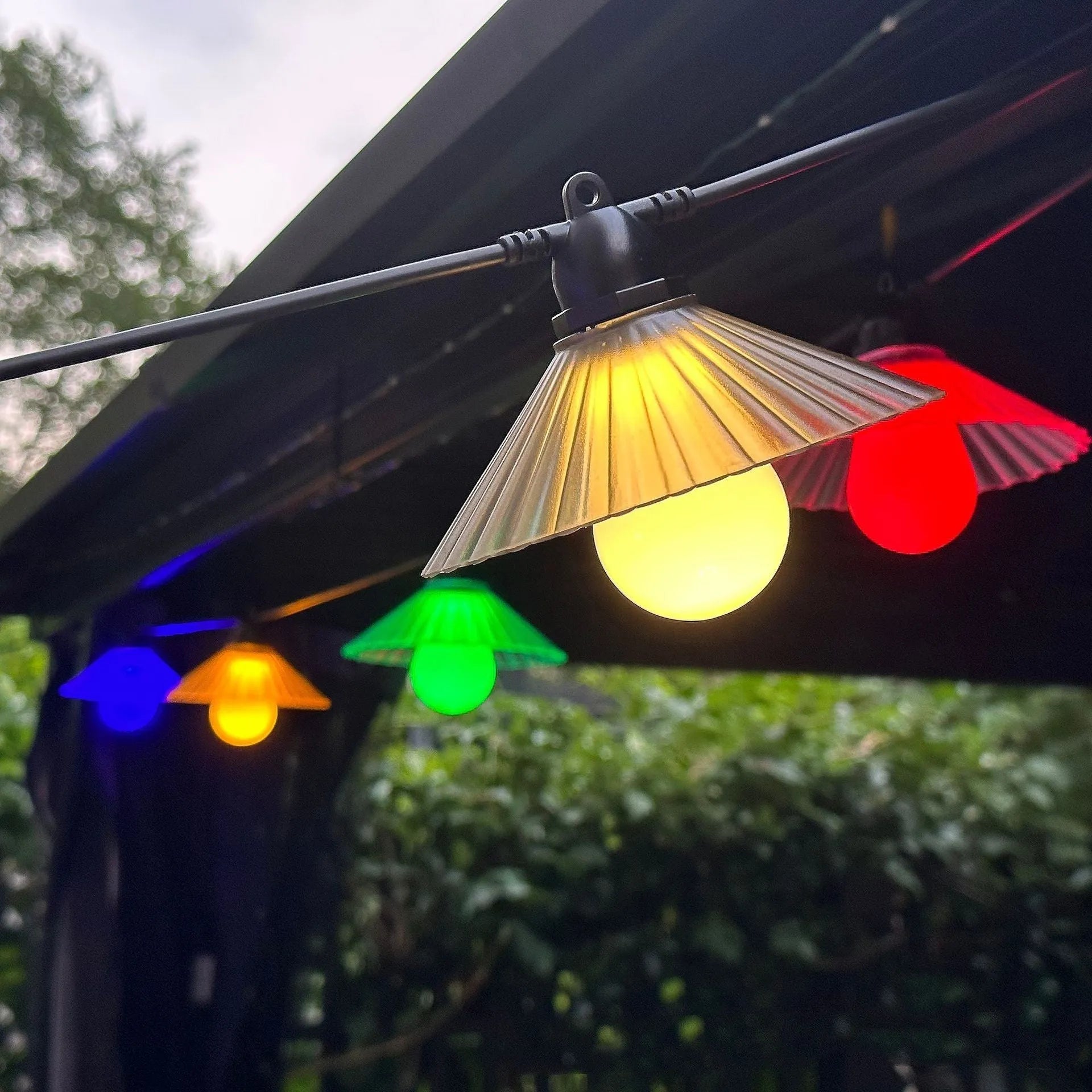 Outdoor LED string lights with flower-shaped bulbs in warm white and coloured options for garden and camping
