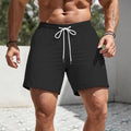 Men's straight leg track shorts in solid colours with loose fit sports styling