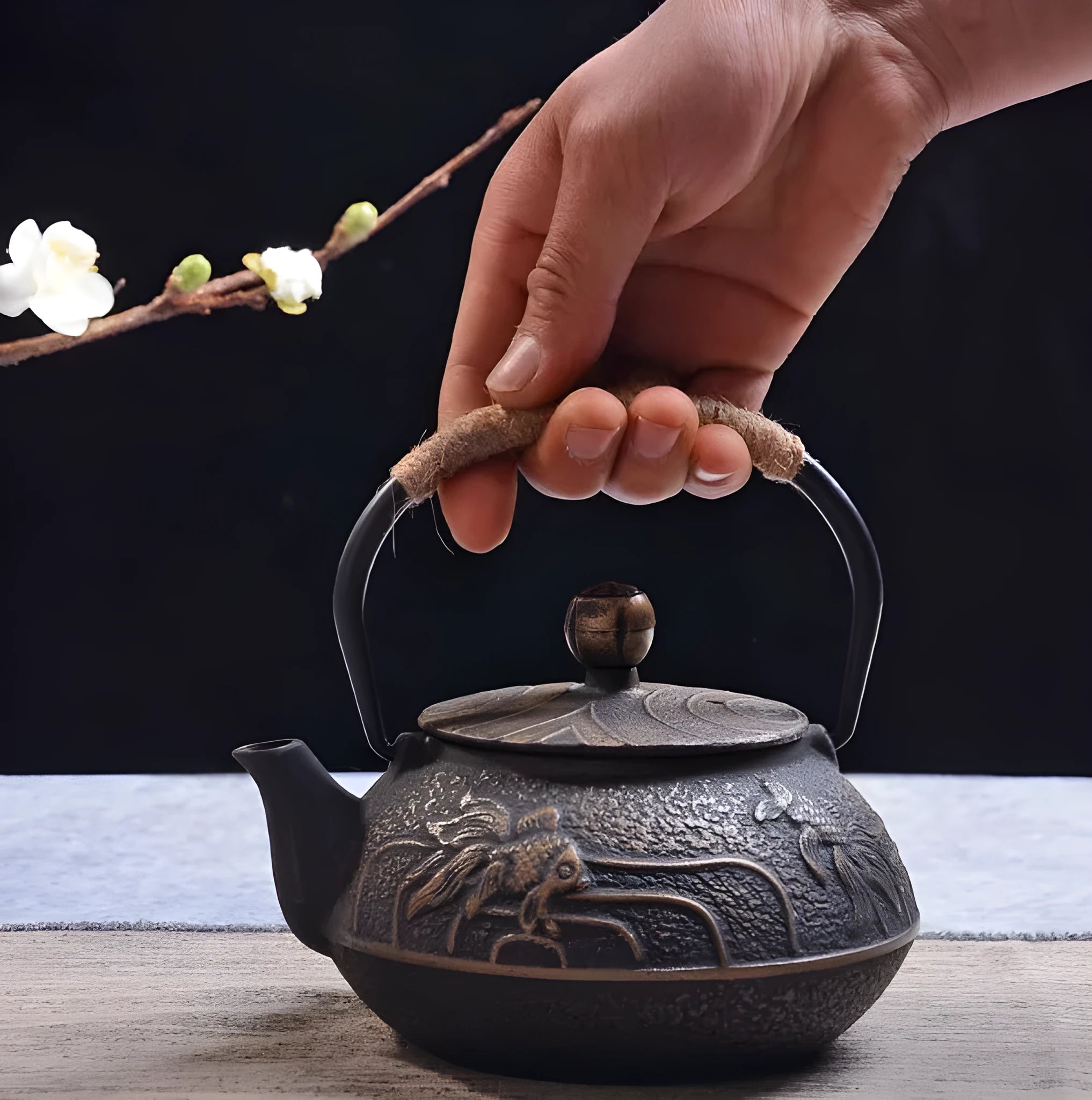 A cast iron teapot with Japanese-style hand-painted decoration, shown in a Bronze finish, with a capacity of 0.9 litres.