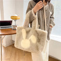 Soft plush shoulder bag with cartoon rabbit ears in one of six solid colours.