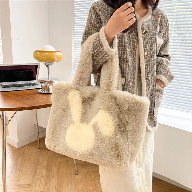 Soft plush shoulder bag with cartoon rabbit ears in one of six solid colours.