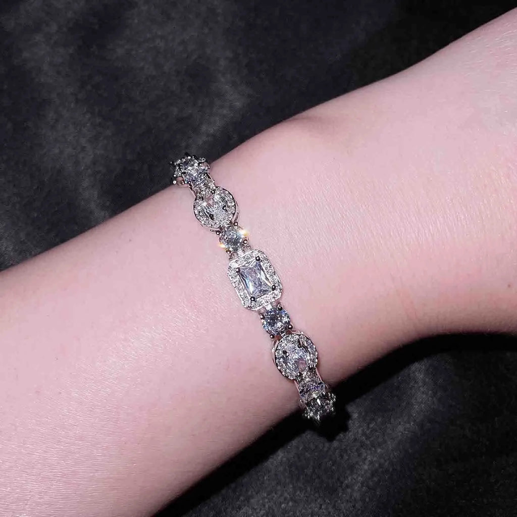 Women's geometric bracelet with zircon stones on silver-toned band showing adjustable and fixed length options