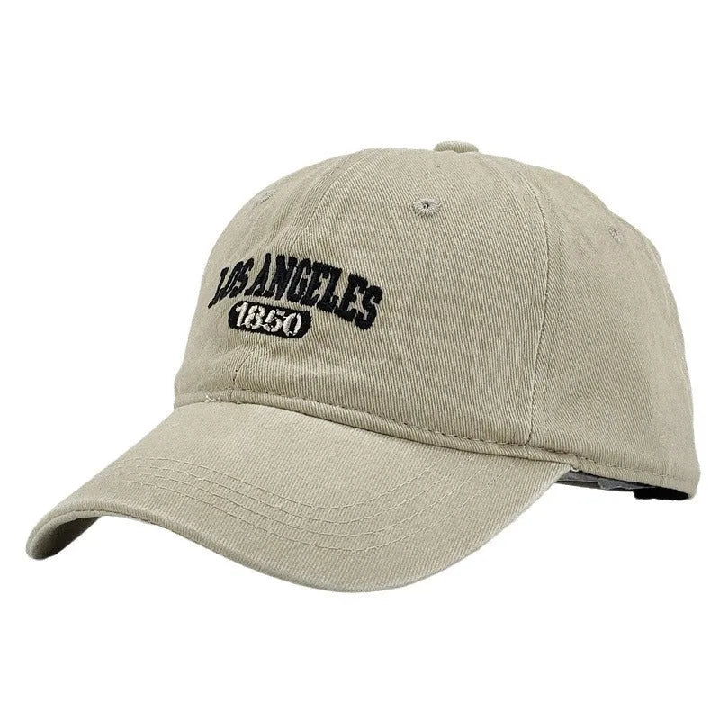 Retro peaked cap with distressed letter embroidery and adjustable sizing in conical crown design