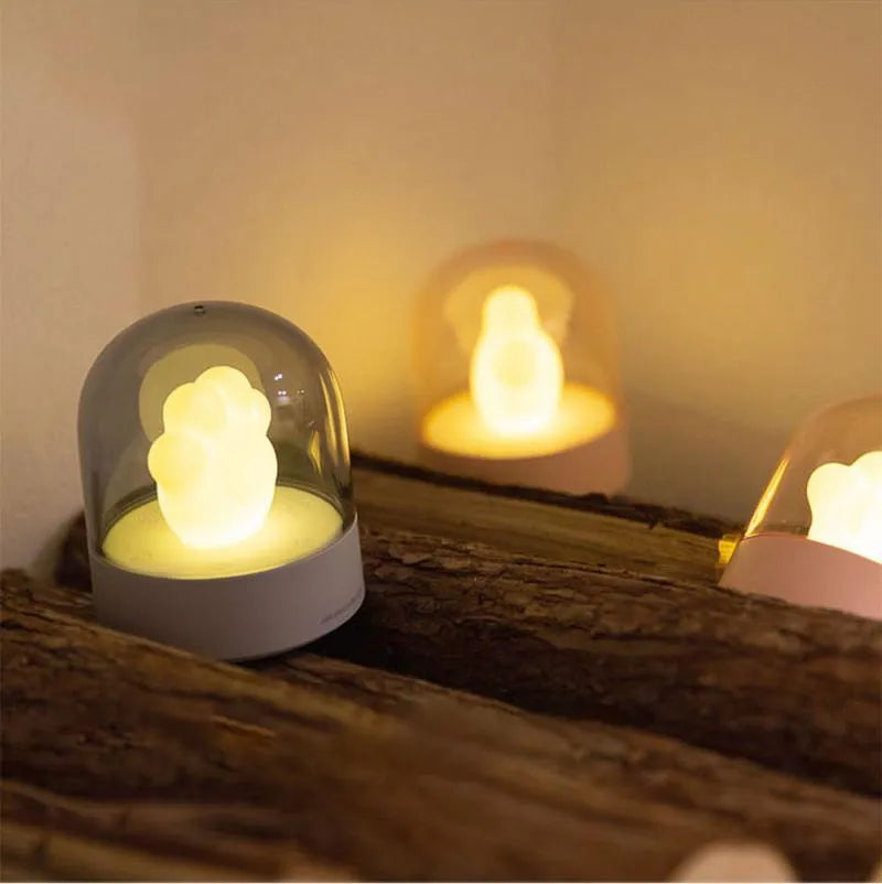 Grey cat paw shaped USB rechargeable night light with rotating musical display