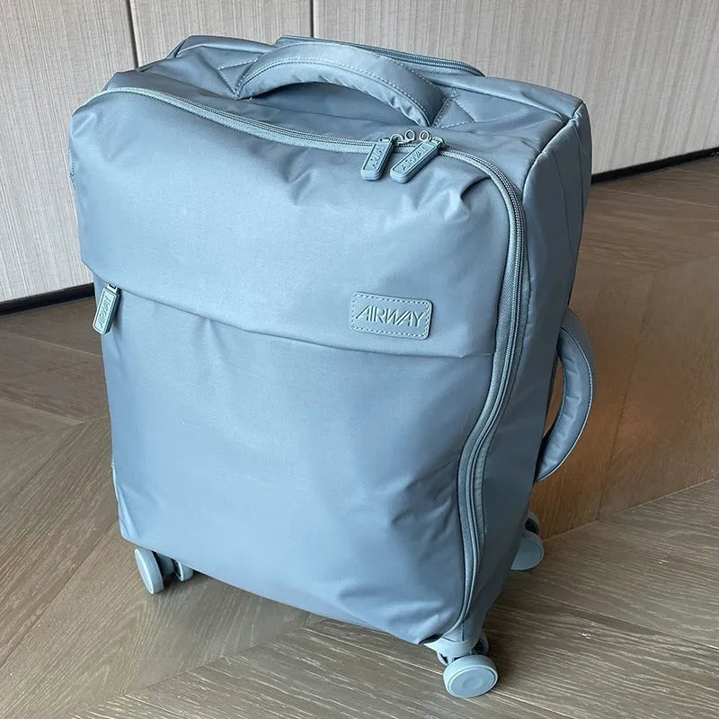 Ultra-light waterproof Oxford cloth suitcase with universal wheels in a bluestone green colour.
