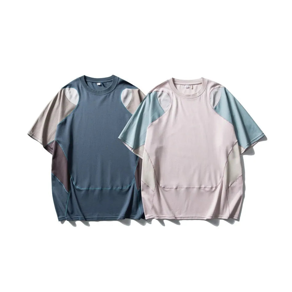 Man wearing a loose fit patchwork t-shirt in a solid colour with short raglan sleeves.